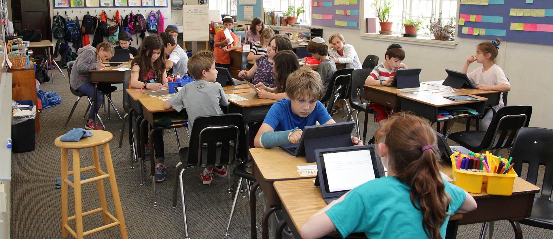 Perelman classroom filled with students each using iPad tablets